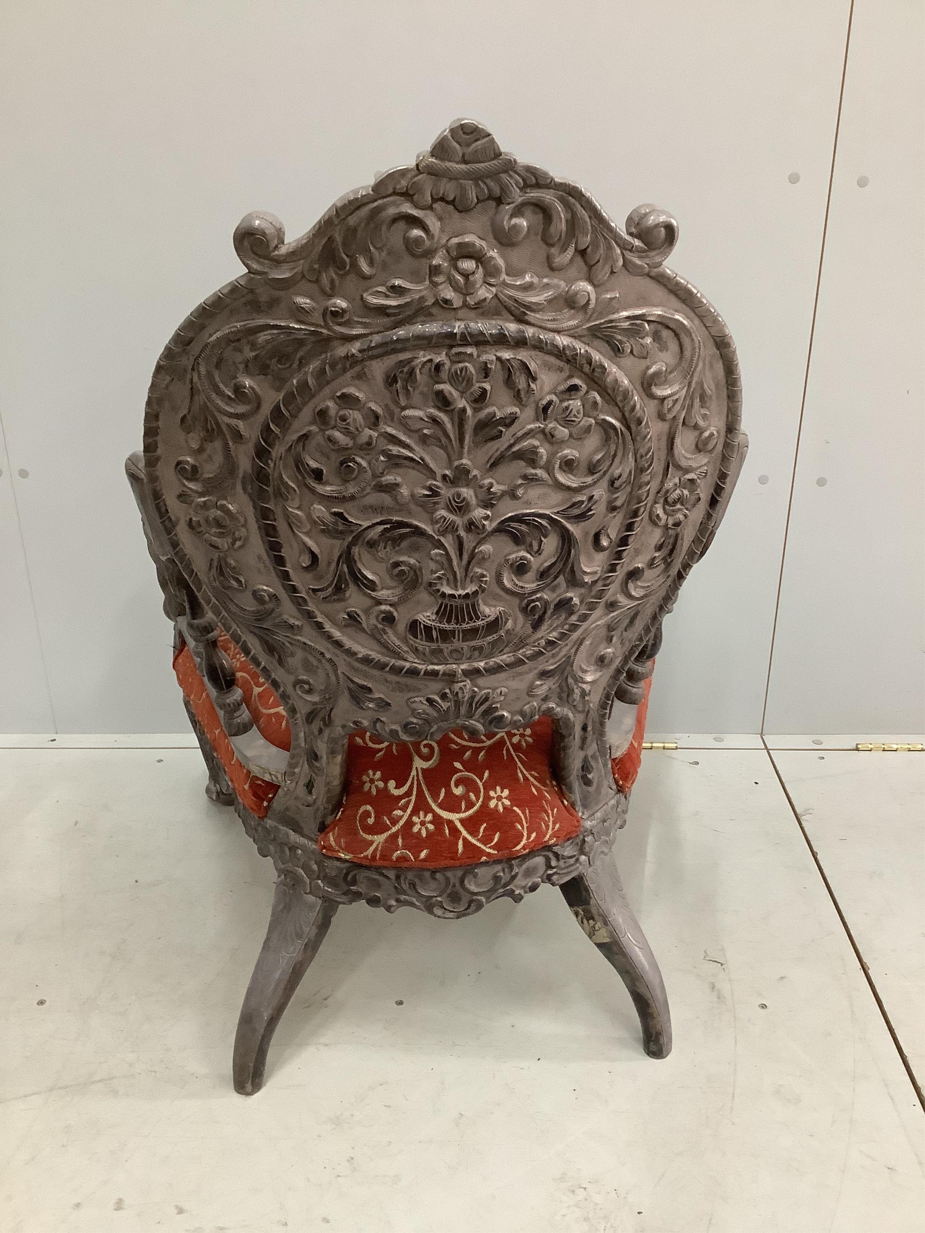 An Indian white metal overlaid armchair, width 72cm, depth 55cm, height 98cm. Condition - good